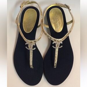 CHANEL Gold T-Strap Sandals with Black Footbed and Crystal CC